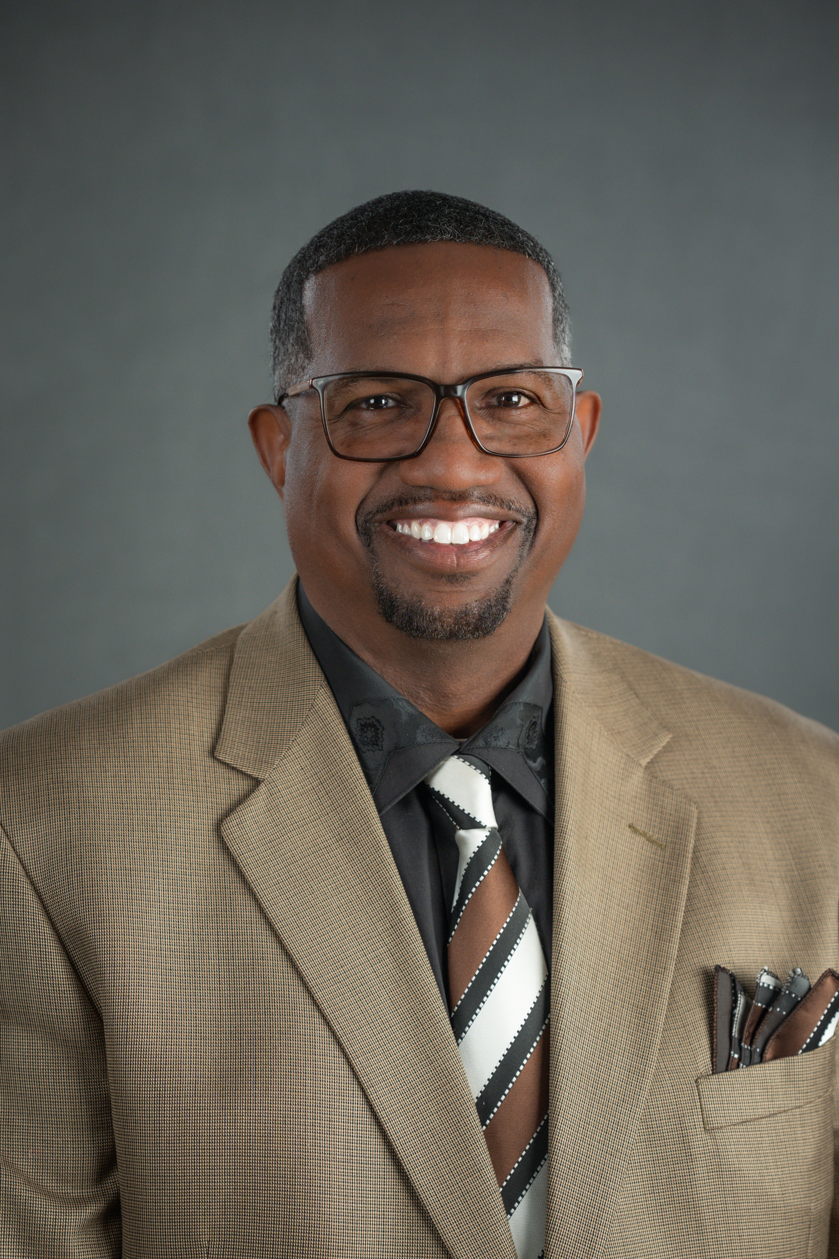 A man wearing a brown suit.